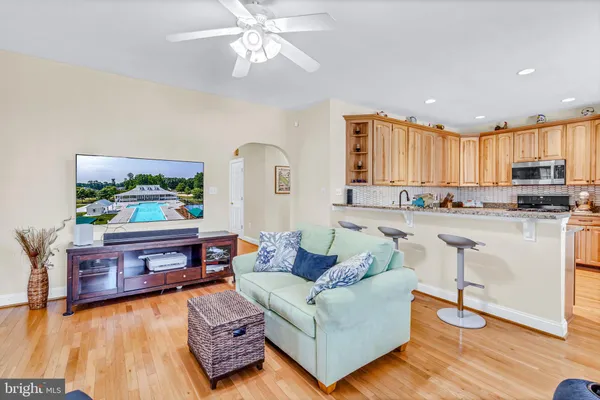 a kitchen with kitchen island granite countertop a sink refrigerator and cabinets