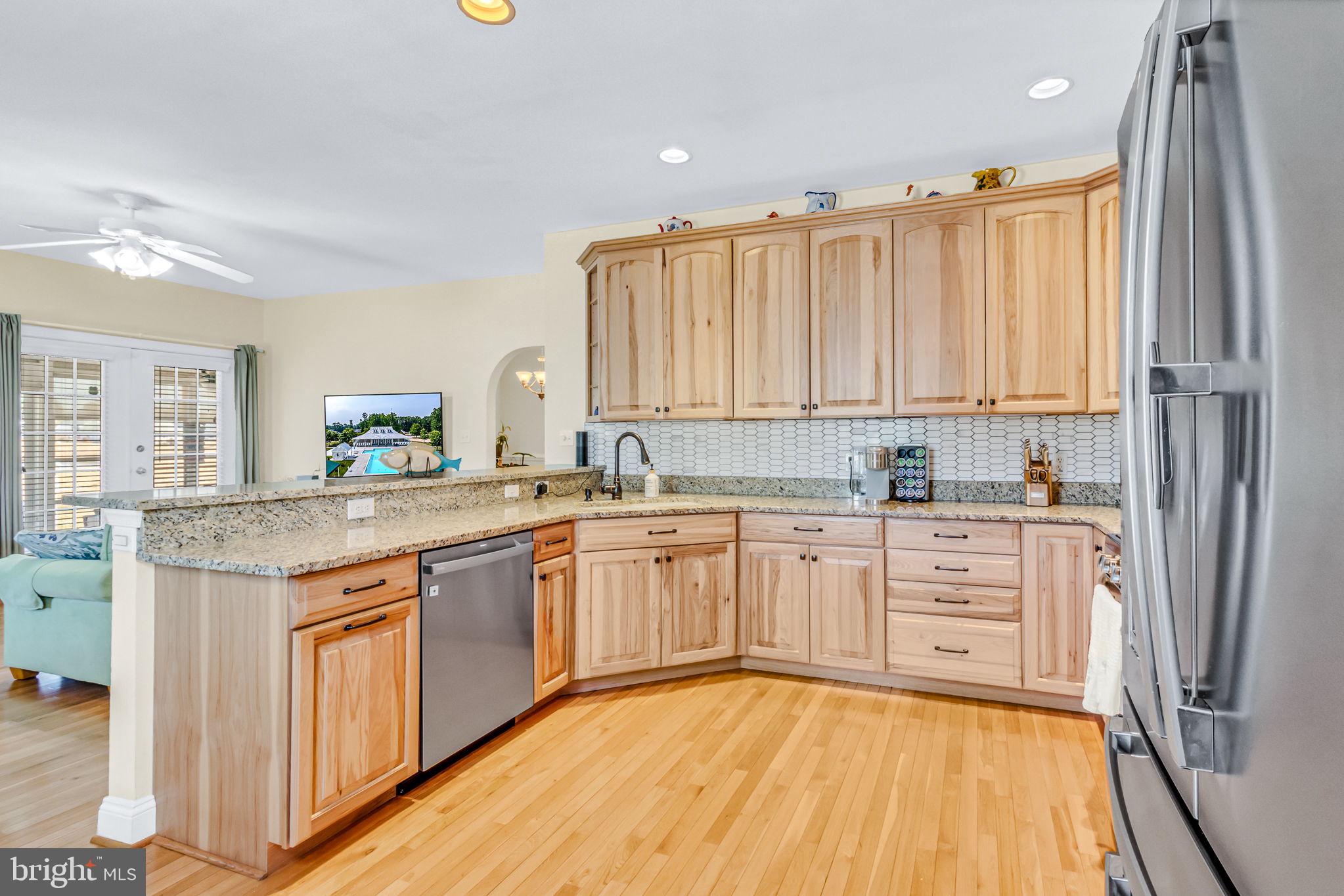 88 Old Field Road Irvington, VA 22480 - Photo 25 of 55 a kitchen with stainless steel appliances granite countertop a stove a sink and a refrigerator
