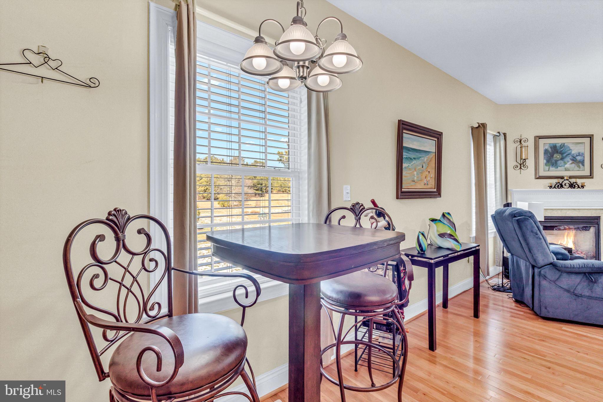 88 Old Field Road Irvington, VA 22480 - Photo 27 of 55 a view of a dining room with furniture wooden floor and a chandelier