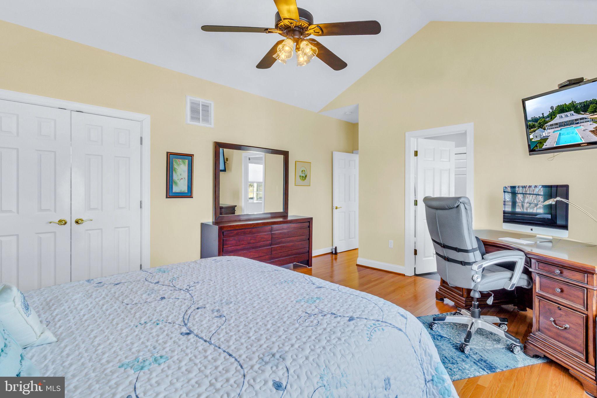 88 Old Field Road Irvington, VA 22480 - Photo 31 of 55 a bedroom with a bed and a chandelier