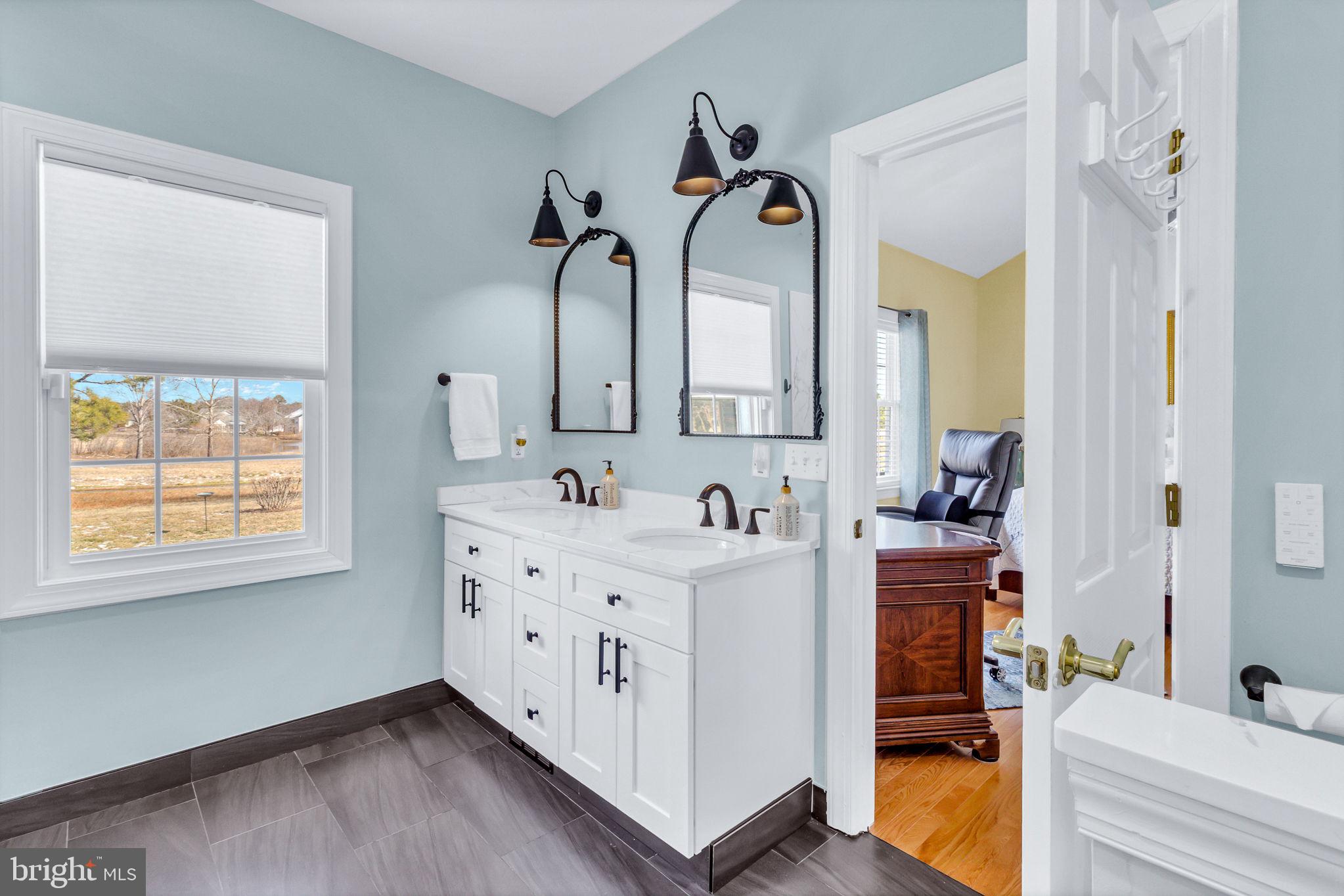 88 Old Field Road Irvington, VA 22480 - Photo 34 of 55 a en suite bathroom with a double vanity sink and a mirror