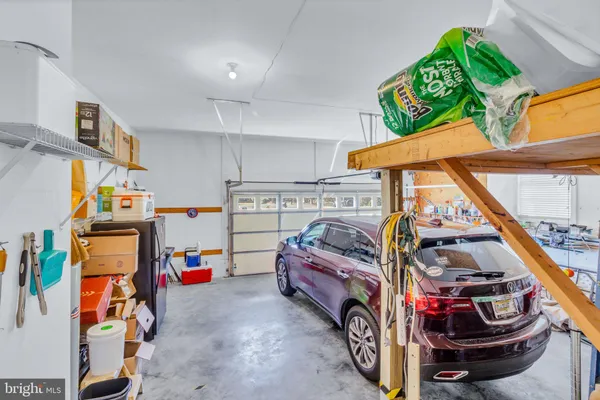 a bathroom with a granite countertop sink a mirror and a shower