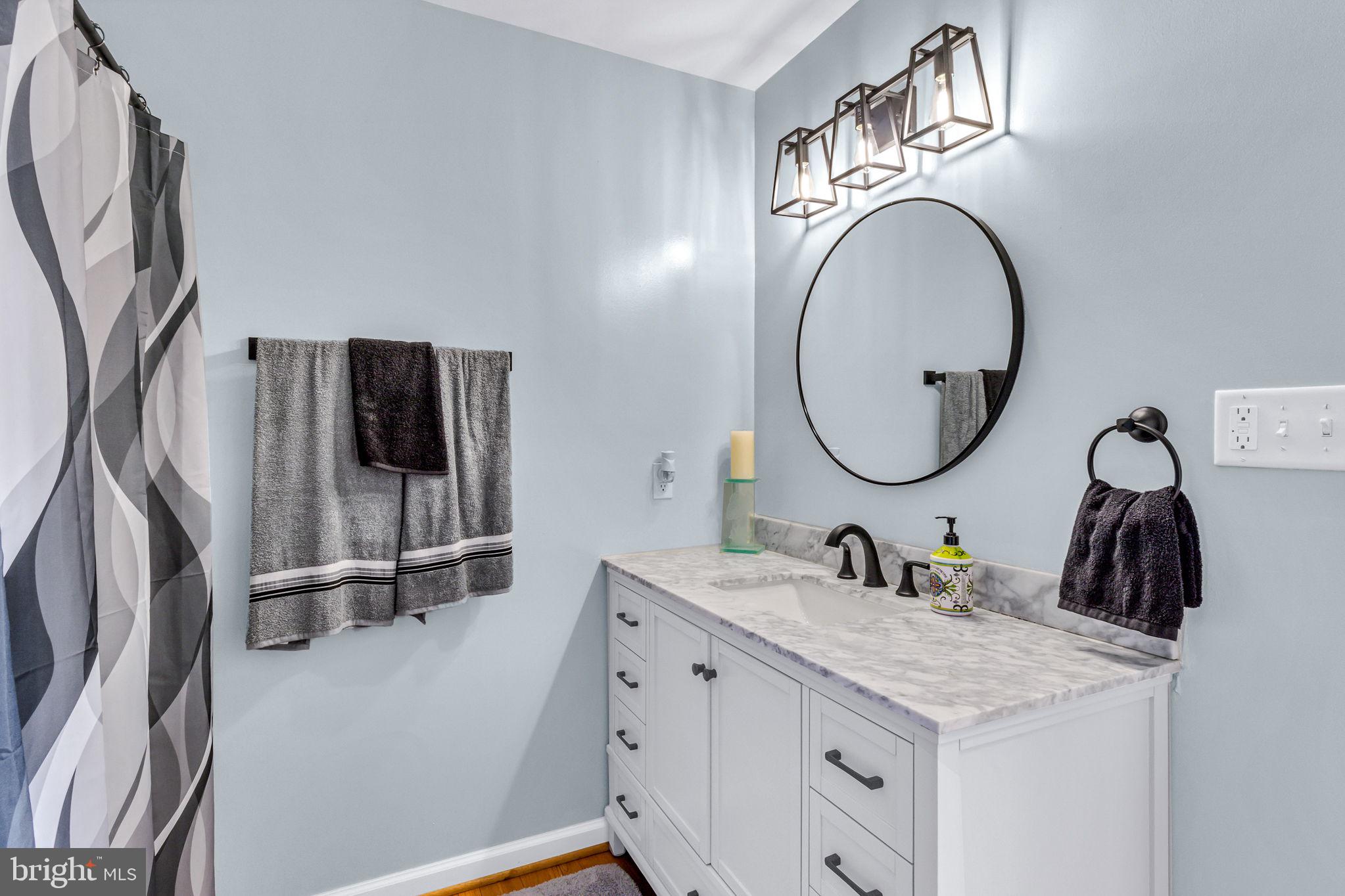88 Old Field Road Irvington, VA 22480 - Photo 41 of 55 a bathroom with a granite countertop sink a mirror and a shower