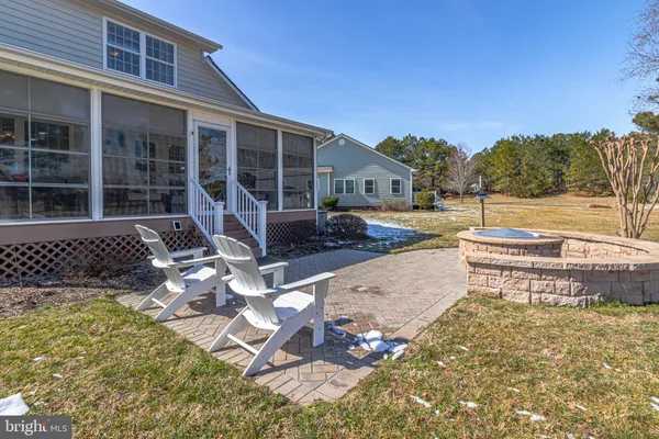 an aerial view of a house with garden space and outdoor seating