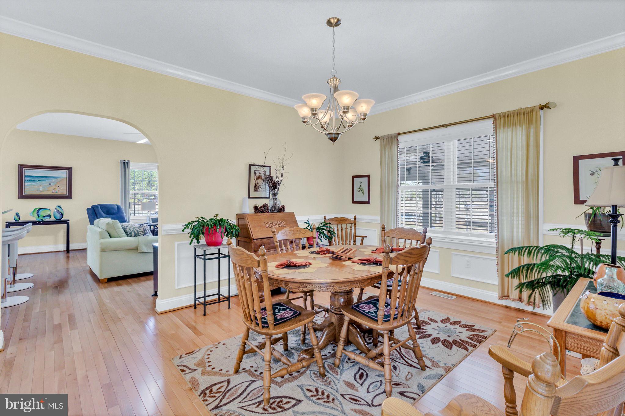 88 Old Field Road Irvington, VA 22480 - Photo 6 of 55 a view of a dining room with furniture window and wooden floor