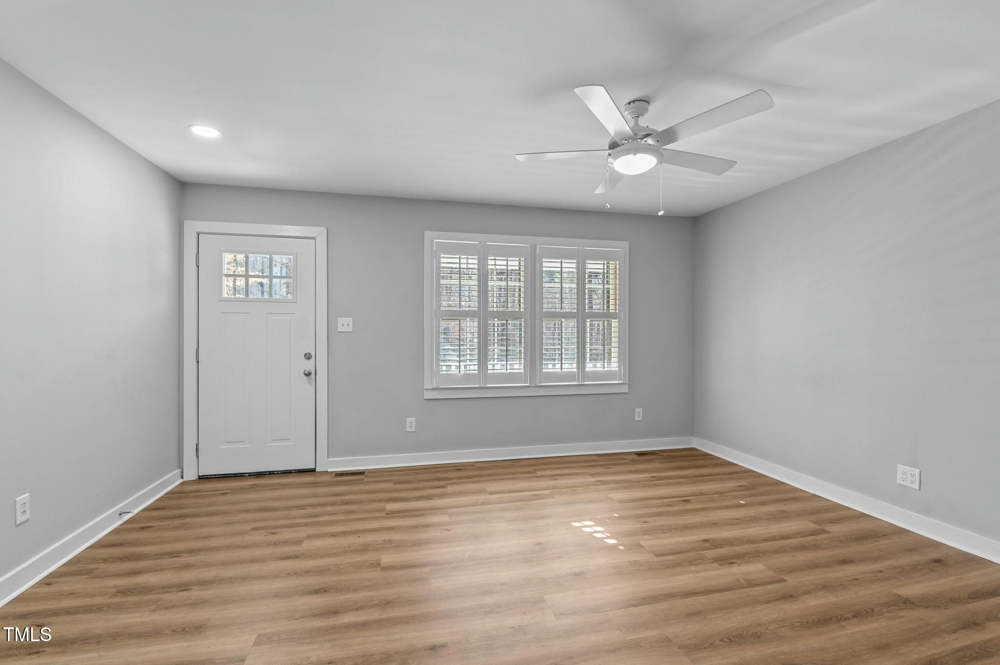 1014 Holden Road Youngsville, NC 27596 - Photo 15 of 54 a view of an empty room with wooden floor and a window