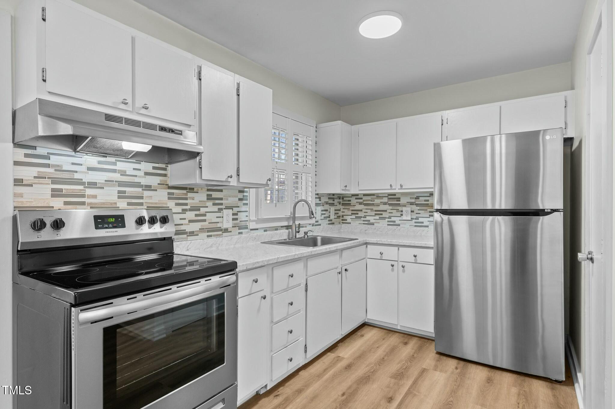 1014 Holden Road Youngsville, NC 27596 - Photo 18 of 54 a kitchen with sink cabinets and stainless steel appliances