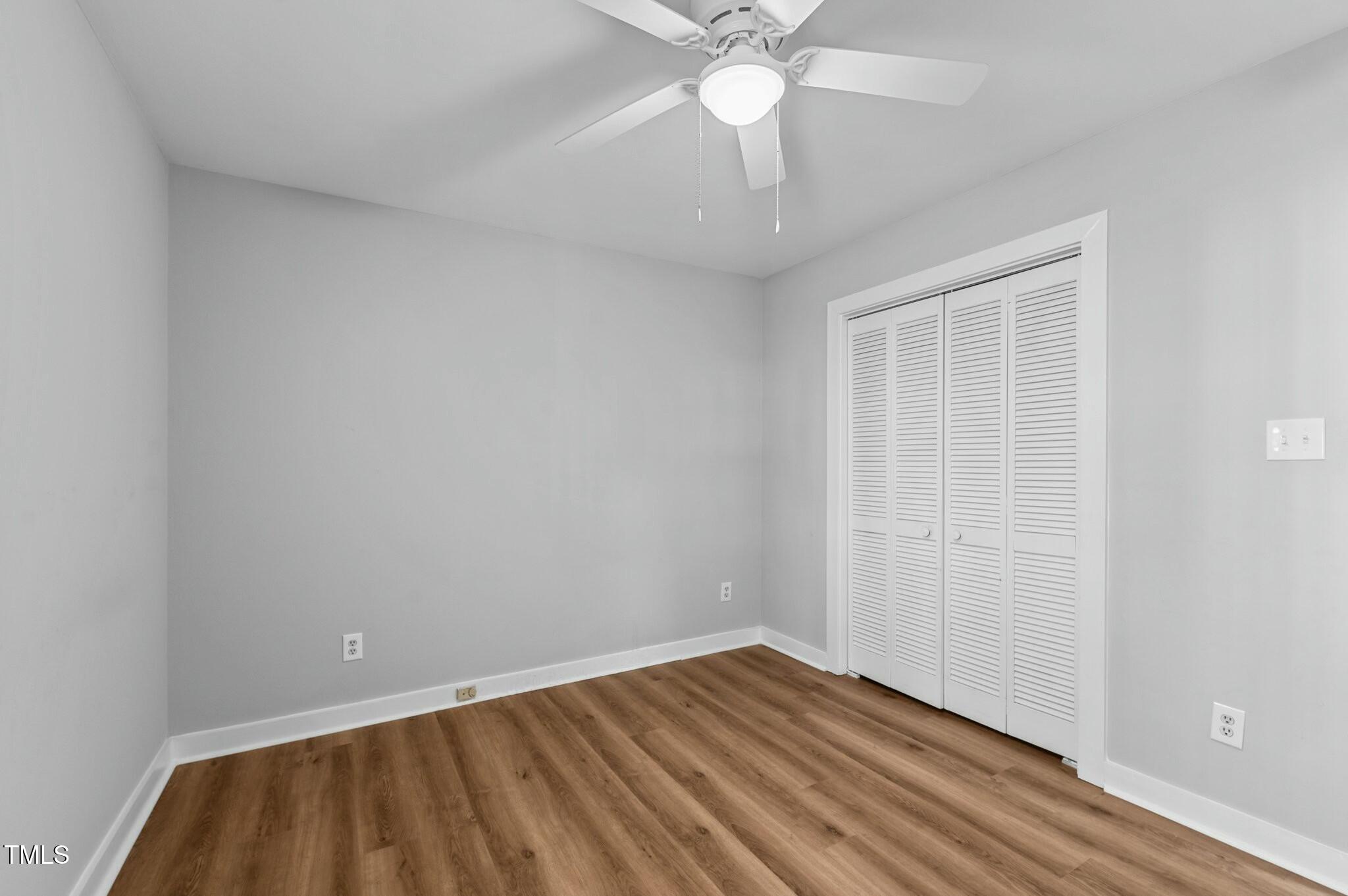 1014 Holden Road Youngsville, NC 27596 - Photo 29 of 54 an empty room with wooden floor and windows