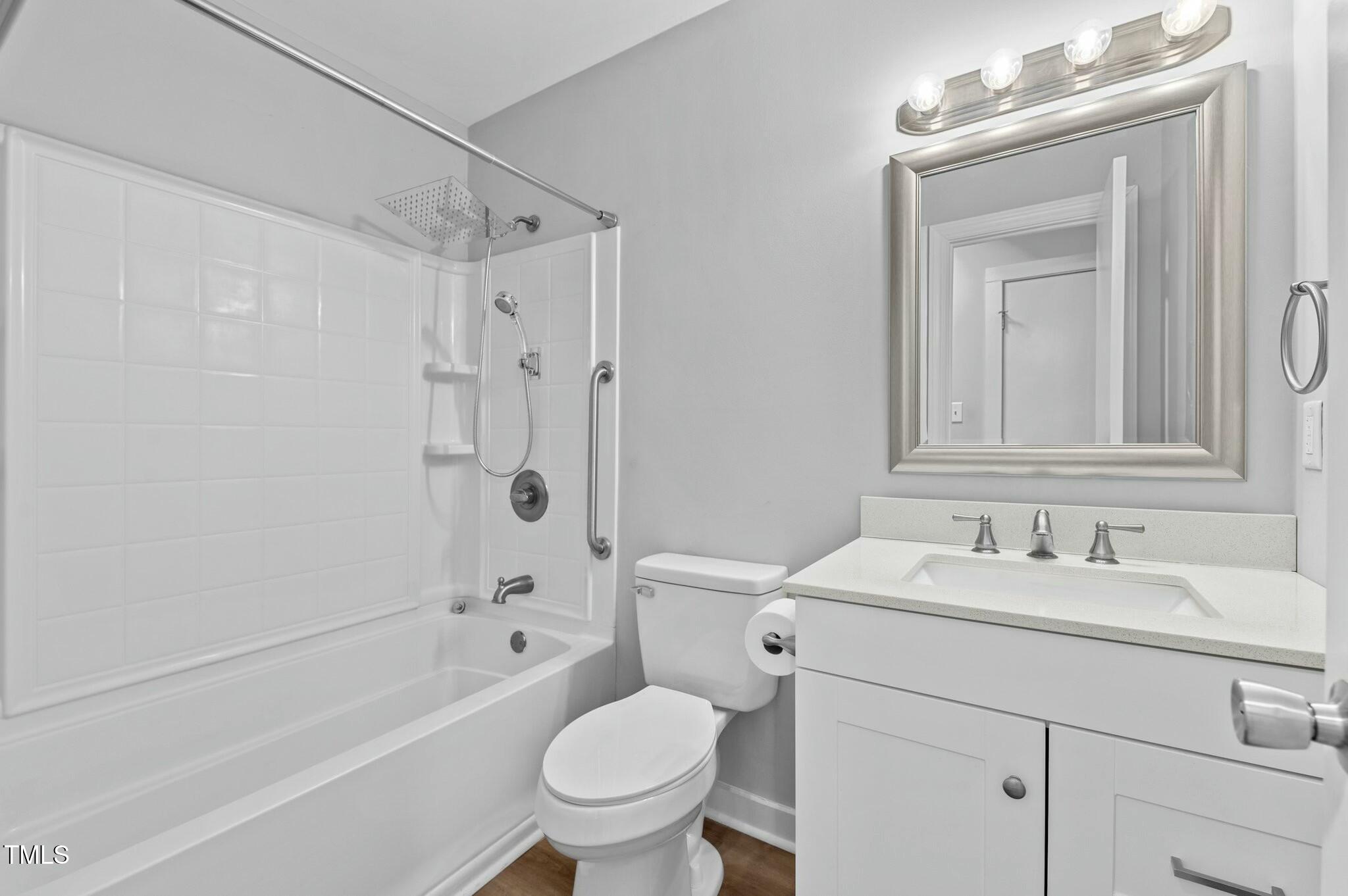 1014 Holden Road Youngsville, NC 27596 - Photo 31 of 54 a bathroom with a sink toilet vanity and shower