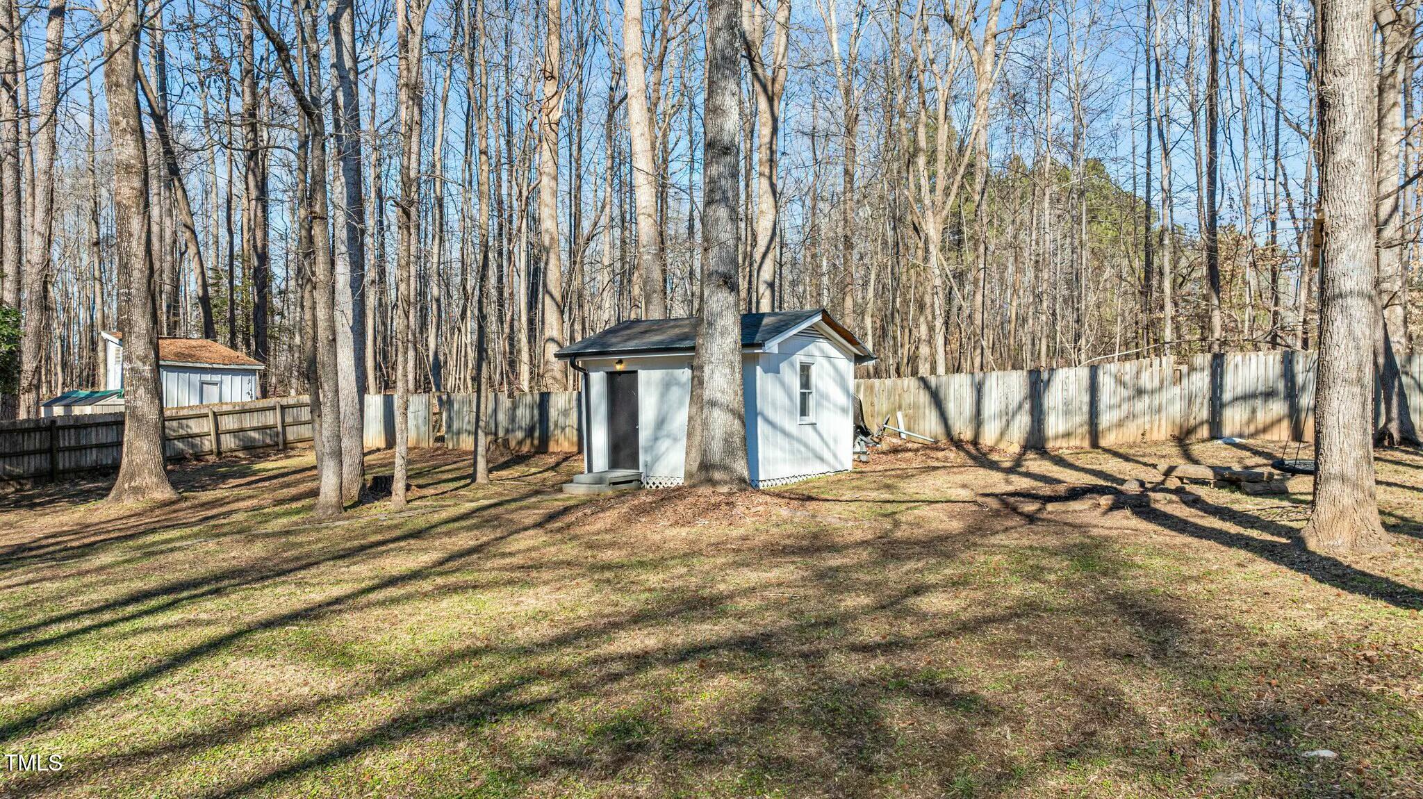 1014 Holden Road Youngsville, NC 27596 - Photo 40 of 54 a view of a backyard with wooden fence