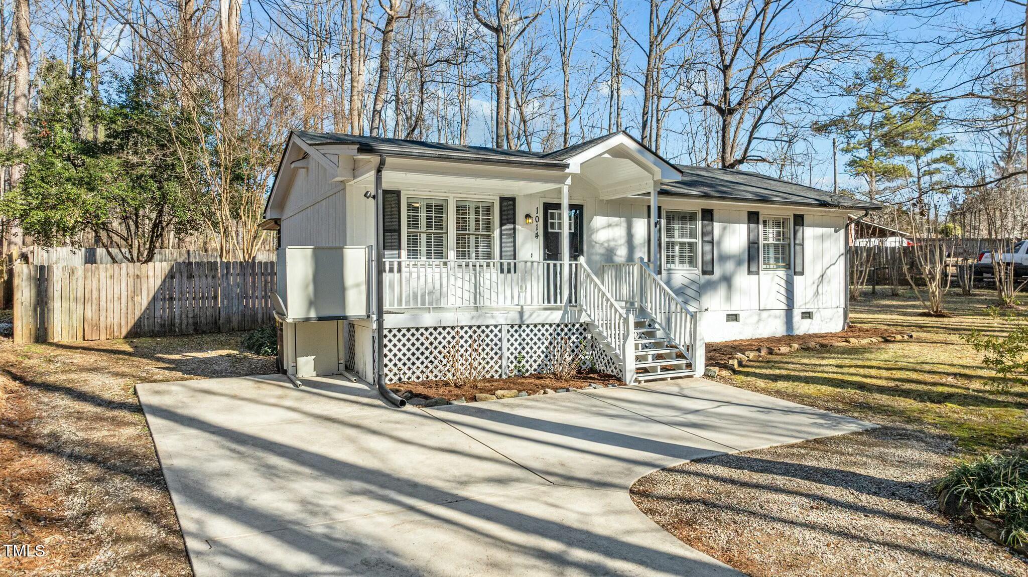 1014 Holden Road Youngsville, NC 27596 - Photo 7 of 54 a front view of a house with a garden and trees
