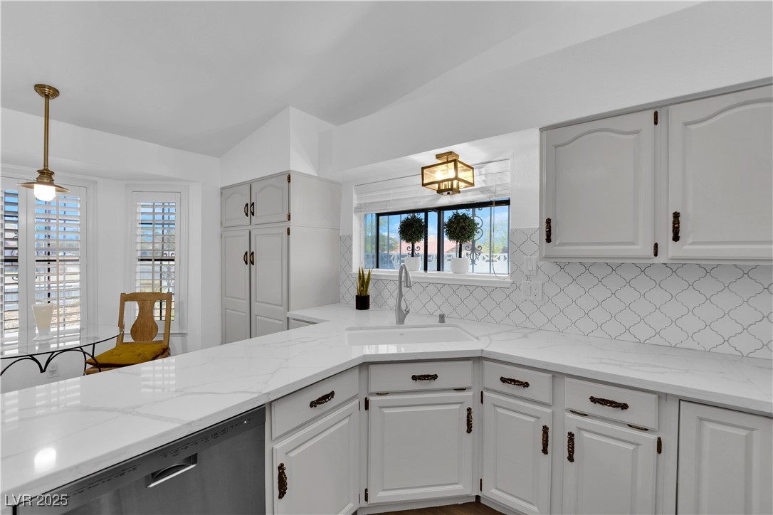 148 Triberg Court Henderson, NV 89074 - Photo 11 of 27 Kitchen featuring stainless steel appliances, pendant lighting, a farm sink, and tasteful backsplash