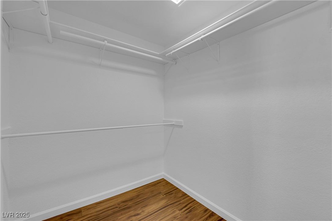 148 Triberg Court Henderson, NV 89074 - Photo 17 of 27 Primary walk in closet featuring wood finished floors
