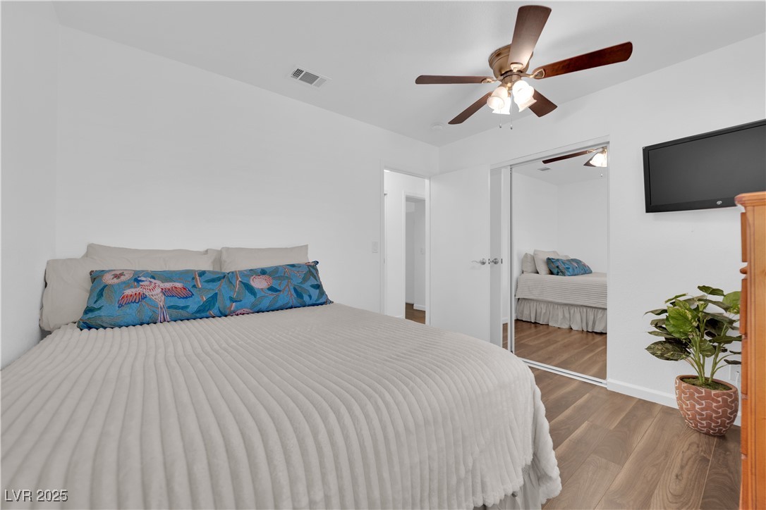 148 Triberg Court Henderson, NV 89074 - Photo 20 of 27 2nd Bedroom featuring a ceiling fan, tv, and LVP wood finished floors