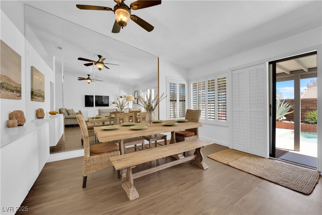 148 Triberg Court Henderson, NV 89074 - Photo 3 of 27 Dining area featuring a Ceiling fan, vaulted ceiling, a wealth of natural light, and wood finished floors