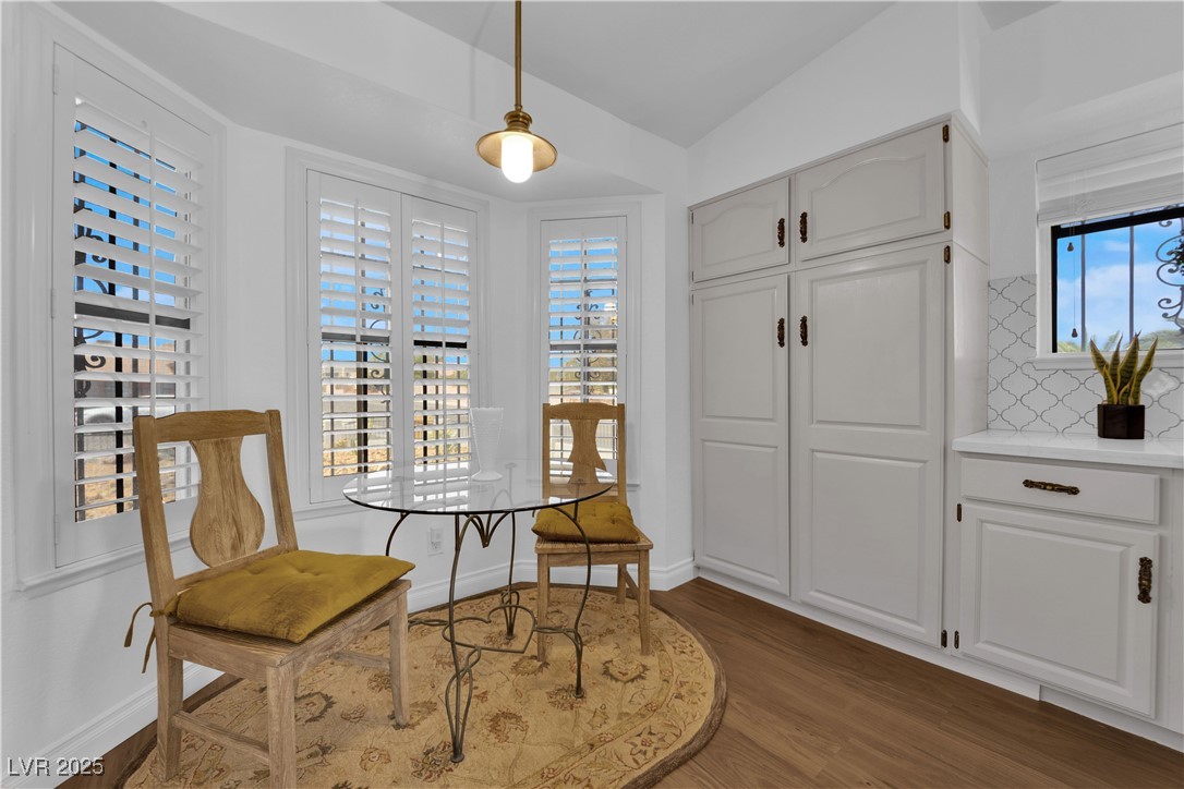 148 Triberg Court Henderson, NV 89074 - Photo 10 of 28 Front kitchen nook area with shutters, dark wood finished floors, and vaulted ceiling.