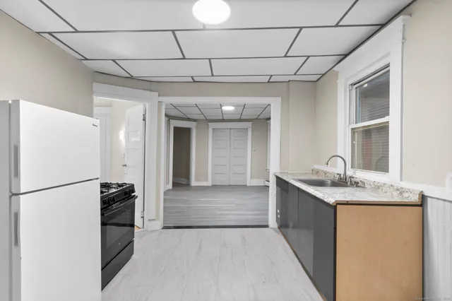 a kitchen with stainless steel appliances granite countertop a refrigerator and a sink