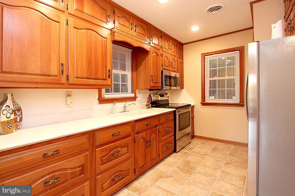 5017 Teen Barnes Road Frederick, MD 21703 - Photo 11 of 30 a kitchen with sink cabinets and window