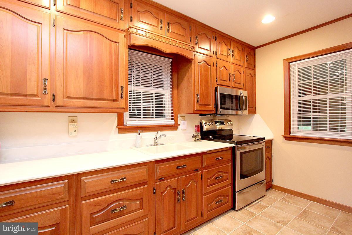 5017 Teen Barnes Road Frederick, MD 21703 - Photo 13 of 30 a kitchen with granite countertop cabinets stainless steel appliances a sink and a window
