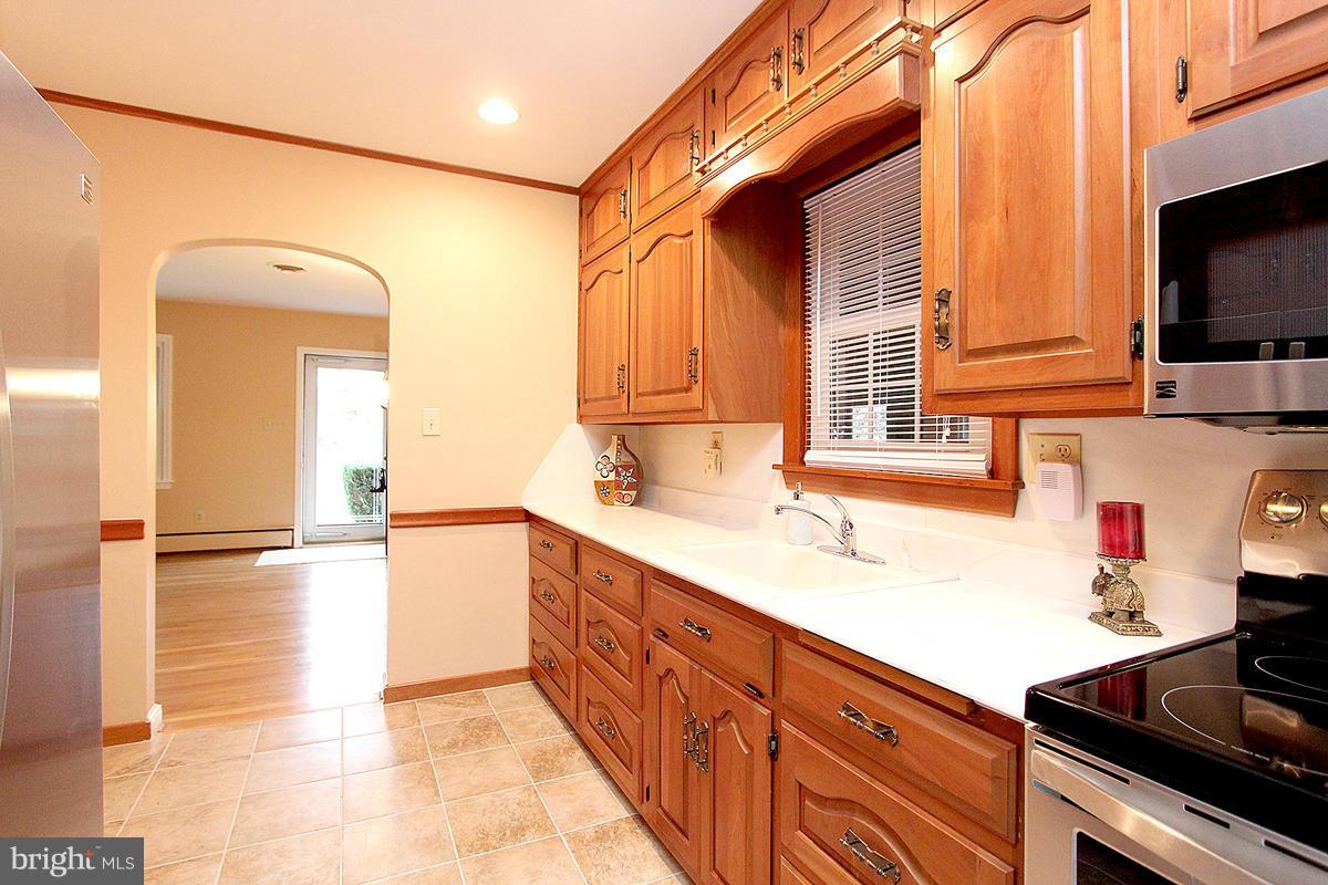 5017 Teen Barnes Road Frederick, MD 21703 - Photo 14 of 30 a kitchen with stainless steel appliances granite countertop a sink and a stove