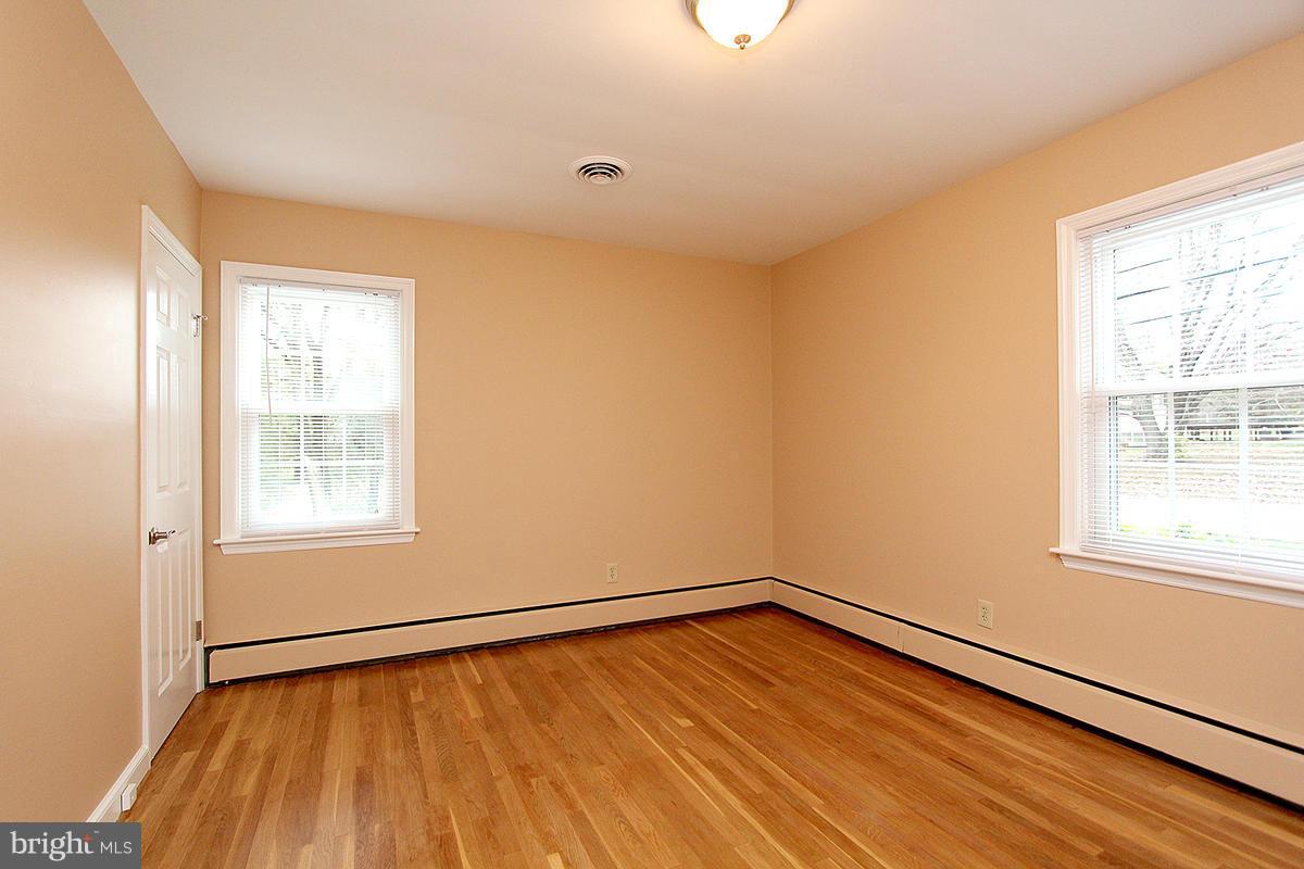 5017 Teen Barnes Road Frederick, MD 21703 - Photo 16 of 30 a view of an empty room with wooden floor and a window