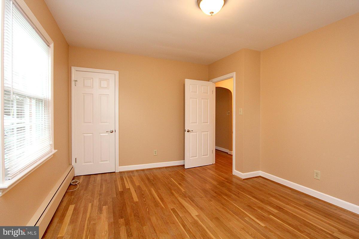 5017 Teen Barnes Road Frederick, MD 21703 - Photo 17 of 30 a view of an empty room with wooden floor and a window