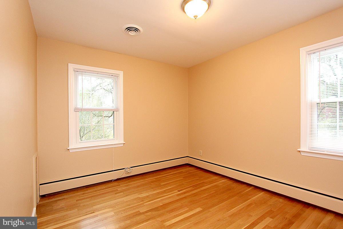 5017 Teen Barnes Road Frederick, MD 21703 - Photo 18 of 30 a view of an empty room with wooden floor and a window