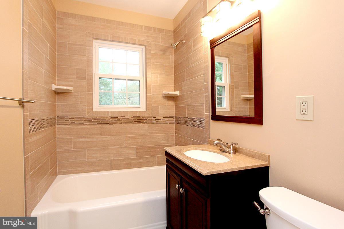 5017 Teen Barnes Road Frederick, MD 21703 - Photo 20 of 30 a bathroom with a sink mirror toilet and bathtub
