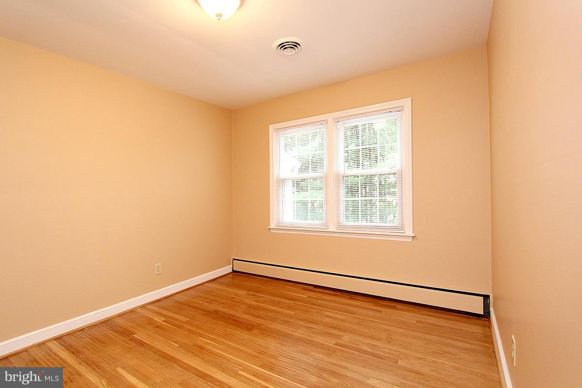 5017 Teen Barnes Road Frederick, MD 21703 - Photo 21 of 30 a view of an empty room with wooden floor and a window