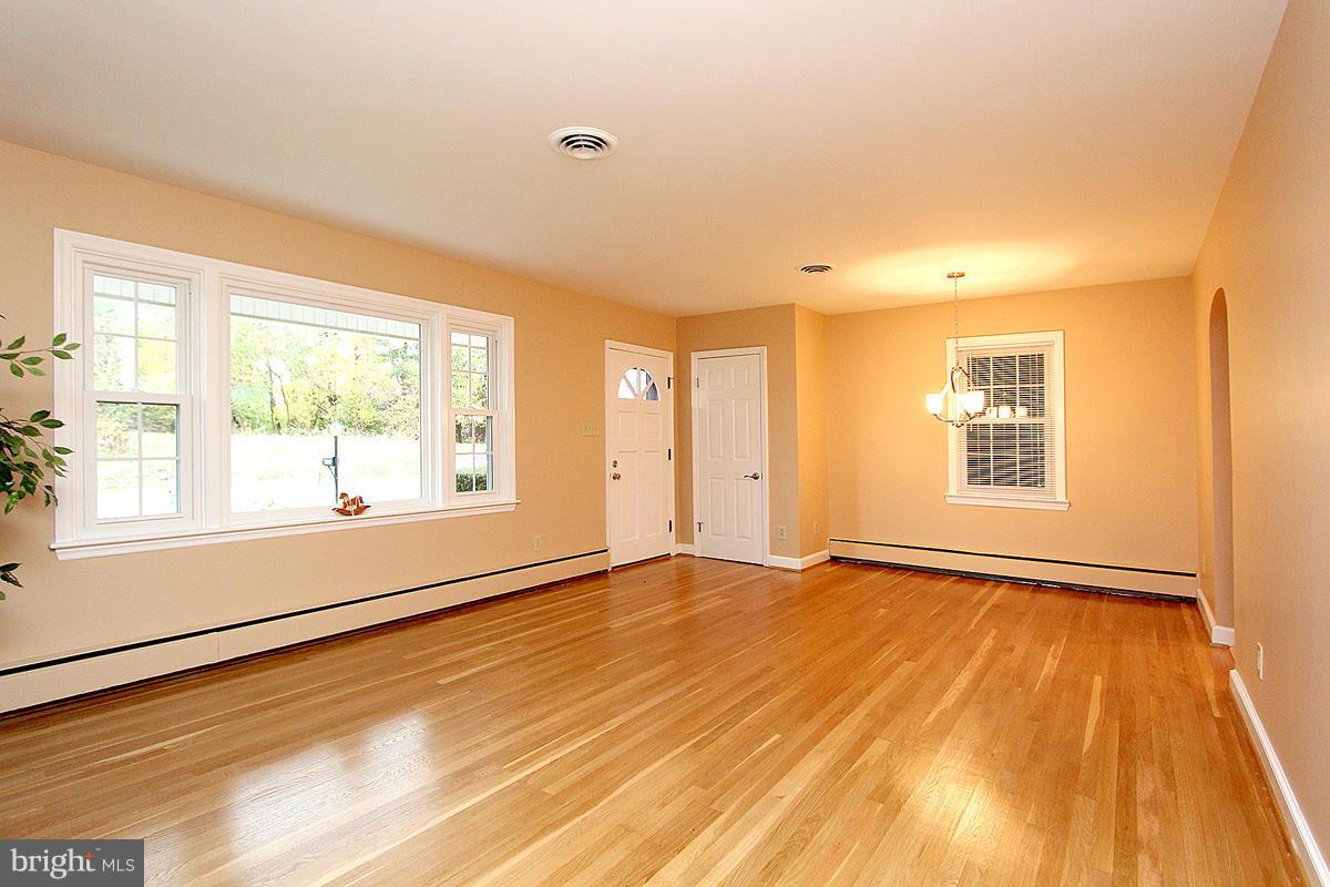 5017 Teen Barnes Road Frederick, MD 21703 - Photo 7 of 30 a view of an empty room with wooden floor and a window