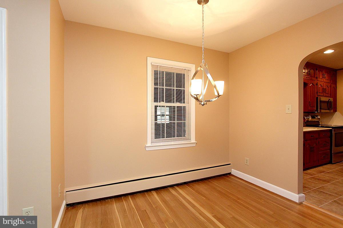 5017 Teen Barnes Road Frederick, MD 21703 - Photo 10 of 30 a view of an empty room with wooden floor and a window