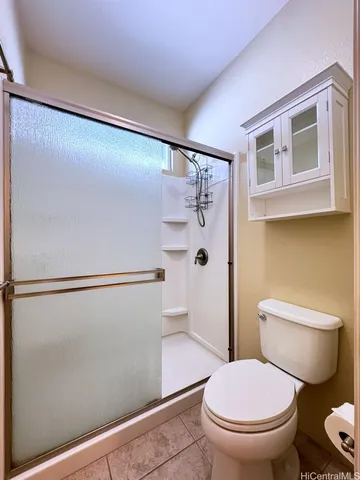 a white toilet sitting next to a bathroom sink