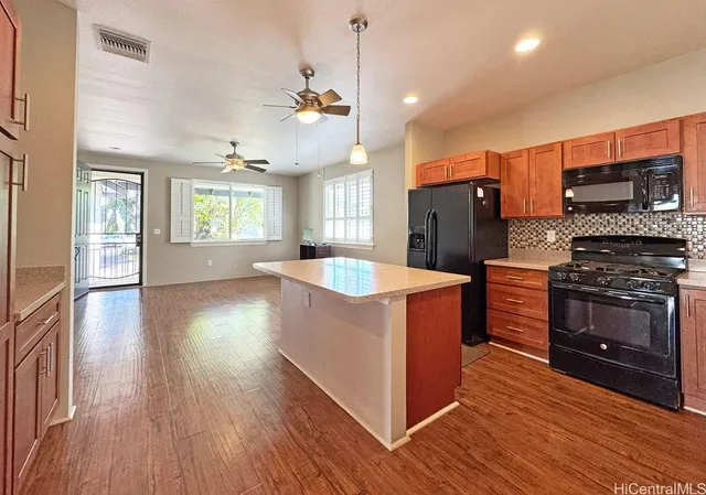 a kitchen with stainless steel appliances granite countertop a stove and a refrigerator