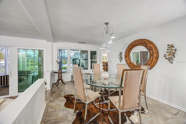 a view of a dining room with furniture wooden floor and chandelier