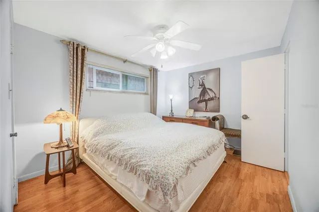 a bedroom with bed and a chandelier