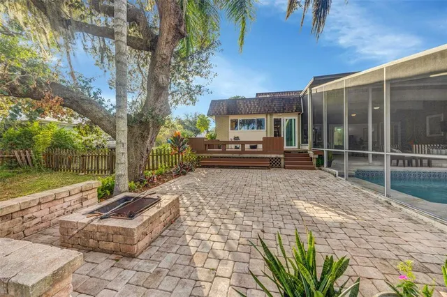 a view of a house with backyard and sitting area