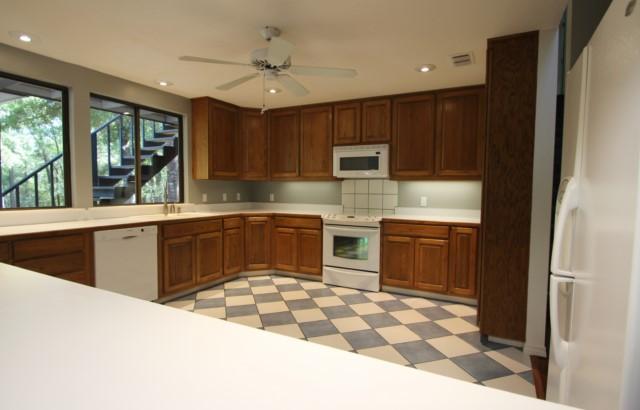 325 Ridge Lake Road Crestview, FL 32536 - Photo 21 of 64 a kitchen with stainless steel appliances a sink a stove a refrigerator cabinets and a window