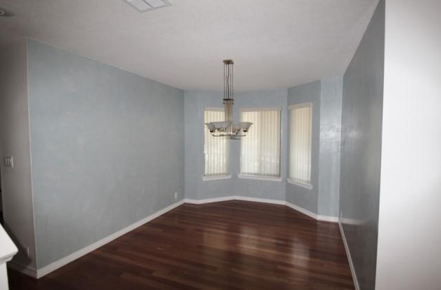 325 Ridge Lake Road Crestview, FL 32536 - Photo 6 of 64 an empty room with wooden floor and windows