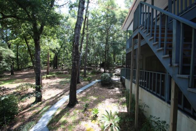325 Ridge Lake Road Crestview, FL 32536 - Photo 51 of 64 a view of a pathway of a house with backyard and wooden floor