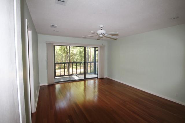 325 Ridge Lake Road Crestview, FL 32536 - Photo 7 of 64 an empty room with wooden floor and windows
