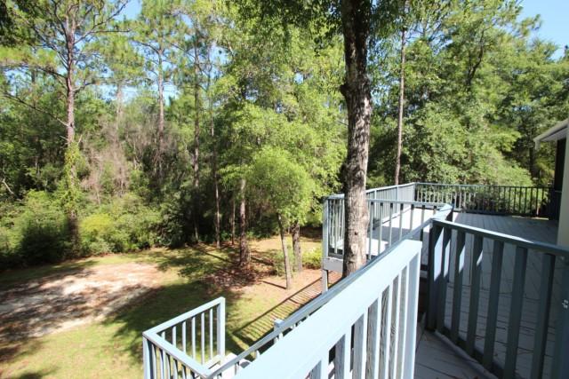 325 Ridge Lake Road Crestview, FL 32536 - Photo 8 of 64 a view of balcony with wooden floor and fence