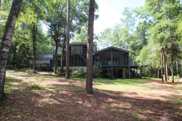 325 Ridge Lake Road Crestview, FL 32536 - Photo 10 of 64 a view of a house with backyard and trees