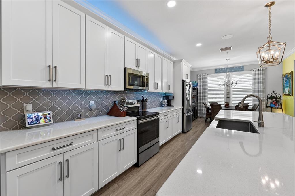 829 Callista Cay Loop Tarpon Springs, FL 34689 - Photo 13 of 91 a kitchen with stainless steel appliances granite countertop a sink a stove and cabinets