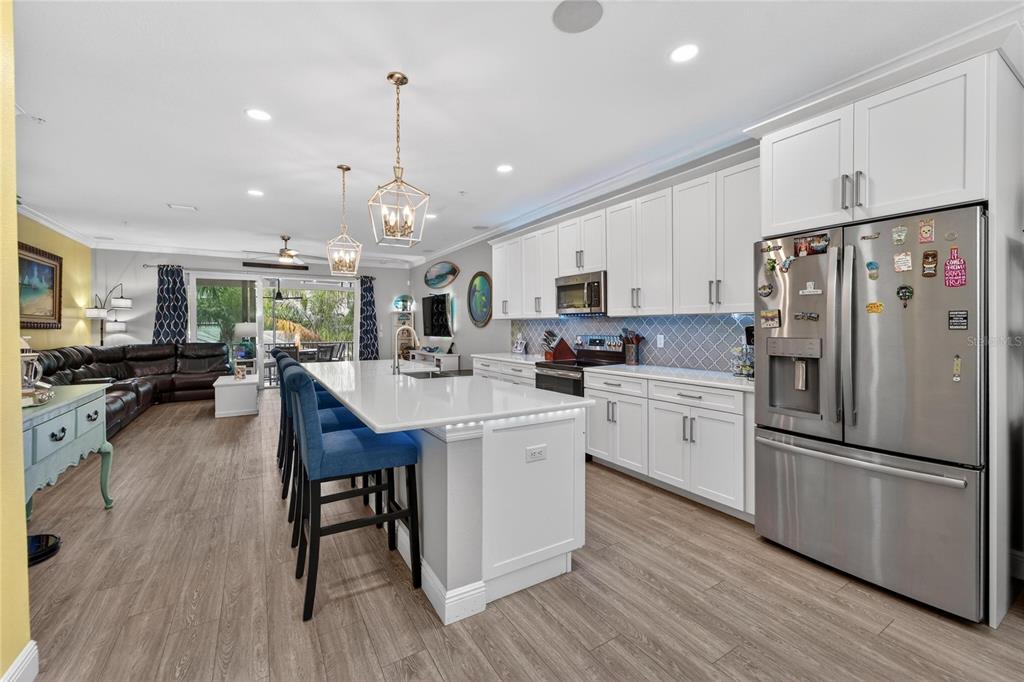 829 Callista Cay Loop Tarpon Springs, FL 34689 - Photo 16 of 91 a kitchen with white cabinets stainless steel appliances and wooden floor