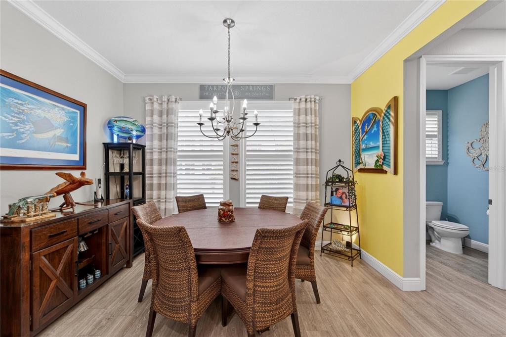 829 Callista Cay Loop Tarpon Springs, FL 34689 - Photo 32 of 91 a view of a dining room with furniture wooden floor and chandelier
