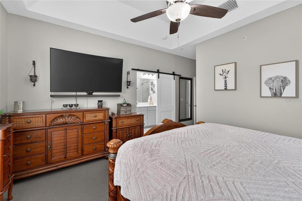 829 Callista Cay Loop Tarpon Springs, FL 34689 - Photo 40 of 91 a spacious bedroom with a bed and a flat screen tv