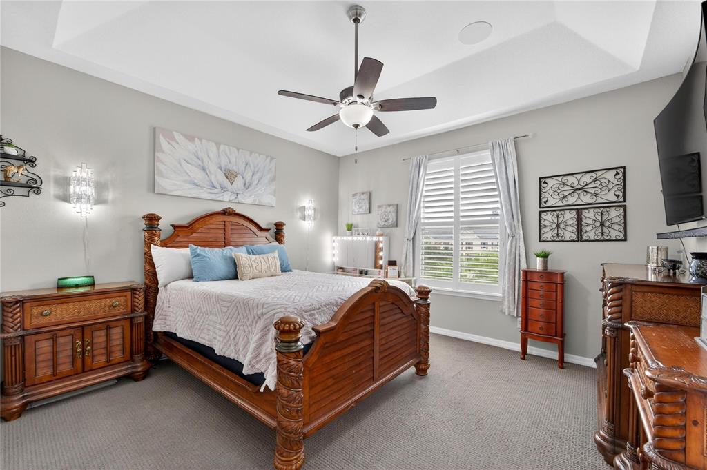 829 Callista Cay Loop Tarpon Springs, FL 34689 - Photo 42 of 91 a bedroom with a bed and a chandelier