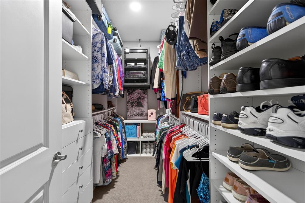 829 Callista Cay Loop Tarpon Springs, FL 34689 - Photo 45 of 91 a view of walk in closet with clothes and shoes