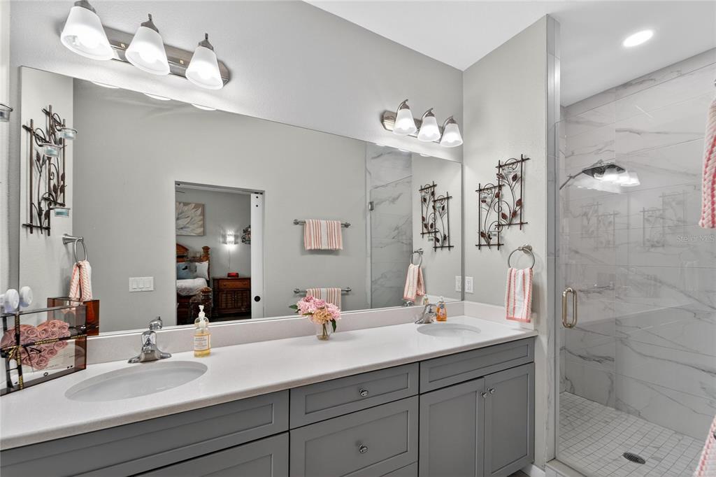 829 Callista Cay Loop Tarpon Springs, FL 34689 - Photo 46 of 91 a bathroom with a double vanity sink mirror and shower