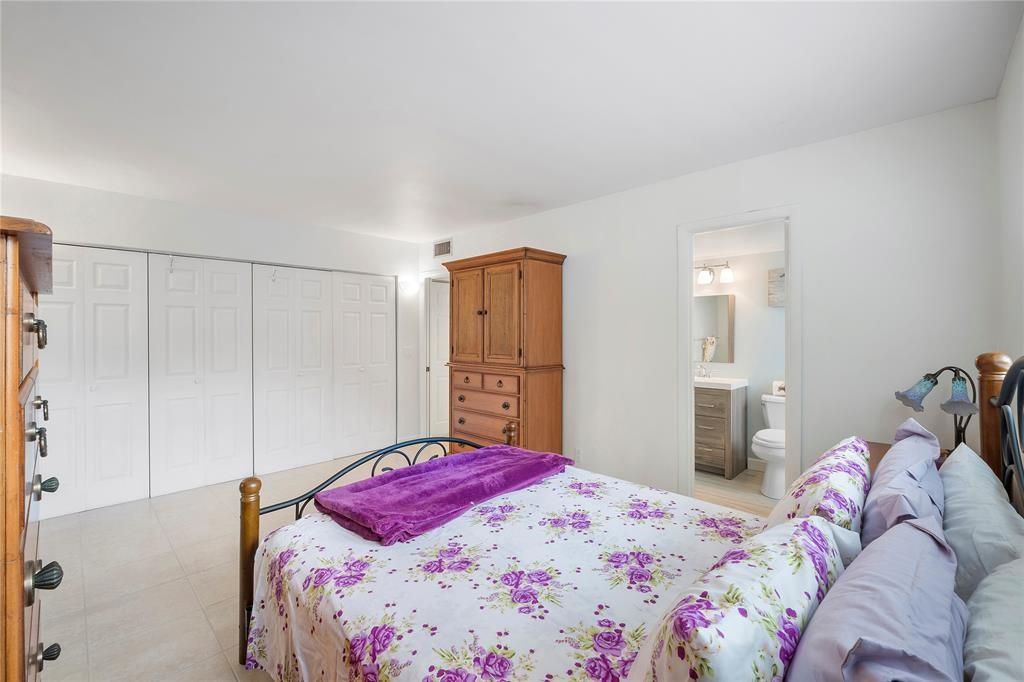 373 Tilford R, Unit 373 Deerfield Beach, FL 33442 - Photo 11 of 36 a bedroom with a bed and a closet